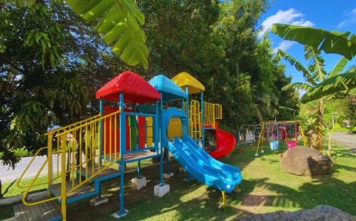 a playground with a slide in a park at Pousada Jovimar in Aparecida