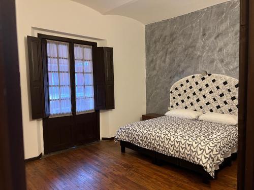 1 dormitorio con cama y ventana grande en Catedral 304, en Puebla