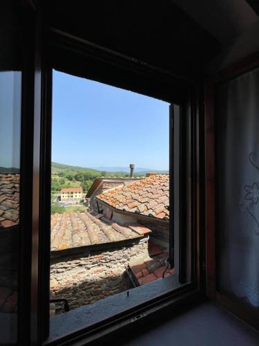 a window with a view of a roof at La Casa in Castello in Ambra