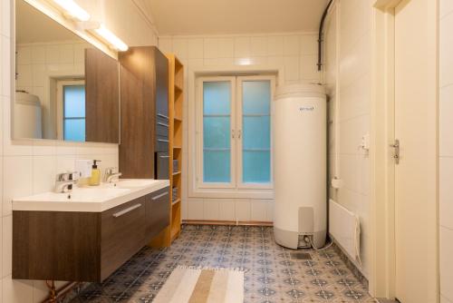 a bathroom with a white sink and a window at Kollen Slottet in Oslo