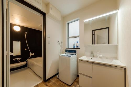 biała łazienka z umywalką i toaletą w obiekcie Wakamiya detached house - Vacation STAY 35575v w Tokio