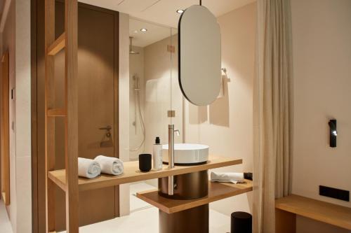 a bathroom with a sink and a mirror at Hotel BERGEBLICK in Bad Tölz