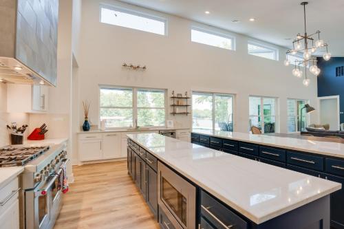 a large kitchen with white cabinets and a large island at Outdoor Oasis Family Malakoff Gem on Cedar Creek! in Malakoff