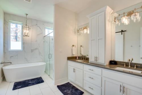 a white bathroom with a tub and a sink at Outdoor Oasis Family Malakoff Gem on Cedar Creek! in Malakoff
