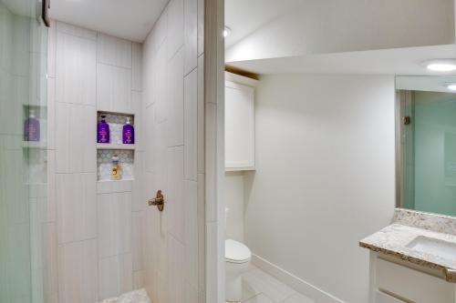 a bathroom with a shower and a toilet and a sink at On Cedar Creek Reservoir Malakoff Home with Pool! in Malakoff