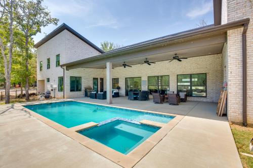 a swimming pool in front of a house at Luxe Waterfront Home in Malakoff with Pool! in Malakoff