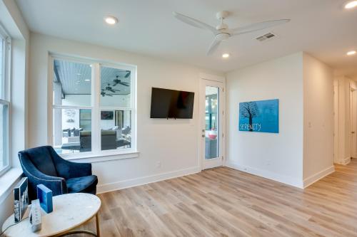 a living room with a blue chair and a table at On Cedar Creek Reservoir Malakoff Home with Pool! in Malakoff