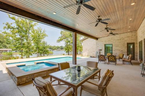a patio with a pool and a table and chairs at Outdoor Oasis Family Malakoff Gem on Cedar Creek! in Malakoff