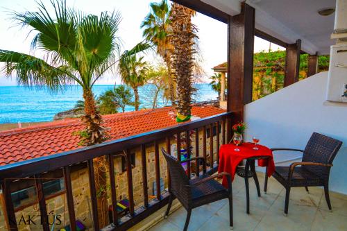 a balcony with a table and chairs and the ocean at Side Kaktüs Boutique otel in Side