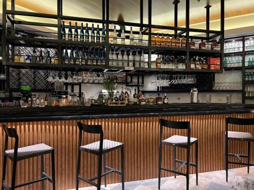 a bar with two chairs sitting at a counter at Hotel Boutique Casa Del Rio in Fortuna