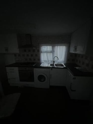 a small kitchen with a sink and a window at Mobile home for rent in Hascombe