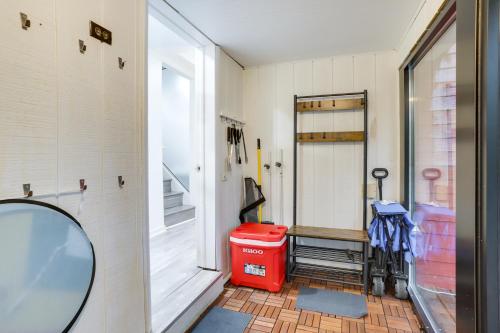 a bathroom with a red trash can and a mirror at South Haven Oasis - Private Hot Tub, Pool and Grill! in South Haven