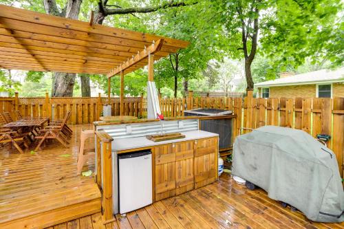 a patio with a grill and a wooden deck at South Haven Oasis - Private Hot Tub, Pool and Grill! in South Haven