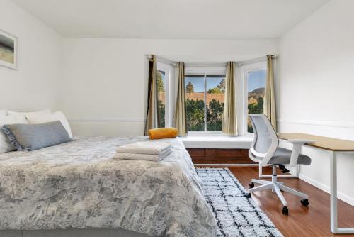 a bedroom with a bed and a desk and a chair at Oaks Garden in Thousand Oaks