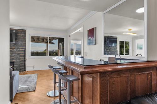 a kitchen with a large wooden bar with stools at Oaks Garden in Thousand Oaks