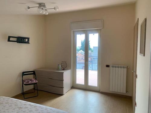 1 dormitorio con 1 cama, vestidor y puerta corredera de cristal en Intero Appartamento a Pescara, en Pescara