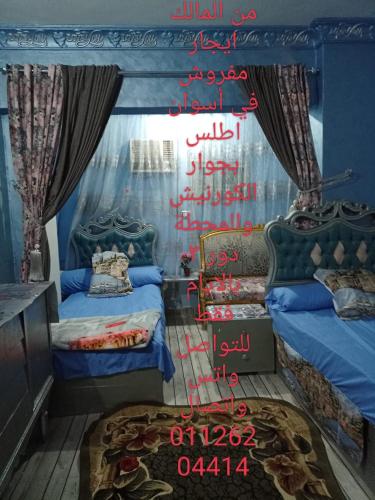 a room with two beds in a room with a wall at اسوان in Aswan