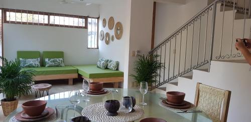 a dining room with a table and a staircase at CASA YAUTEPEC in Puerto Escondido