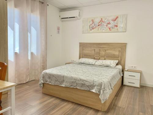 um quarto com uma cama e piso em madeira em Casa Elena de Novelda em Novelda