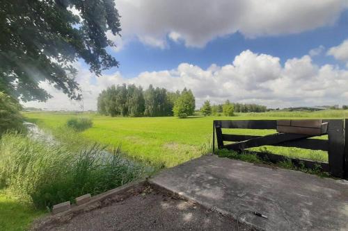 a field with a fence and a field of grass at La Luna - Danny in Heerhugowaard