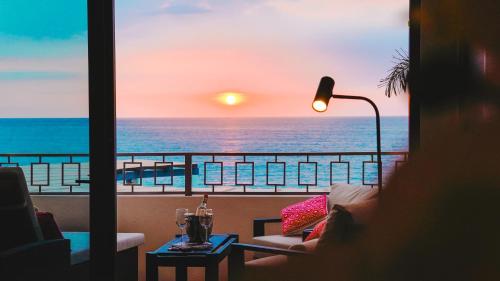 a room with a view of the ocean from a balcony at La Puesta Sayulita in Sayulita