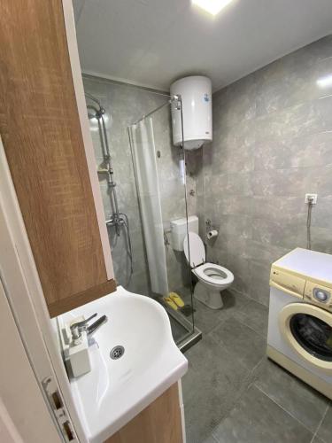 a small bathroom with a sink and a toilet at Apartmani Lipa in Višegrad