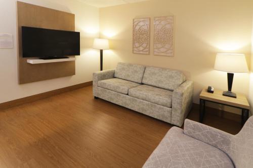 a living room with a couch and a flat screen tv at Wyndham Garden McAllen at La Plaza Mall in McAllen