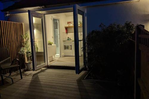 an open door to a patio at night at Oak Tree View - relax, reconnect, explore or work in East Harling
