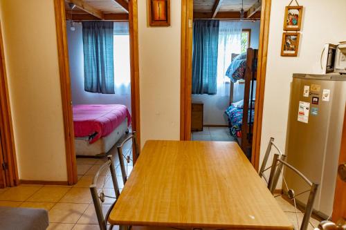 a room with a table and a room with a bed at Departamentos Aquario Papudo in Papudo