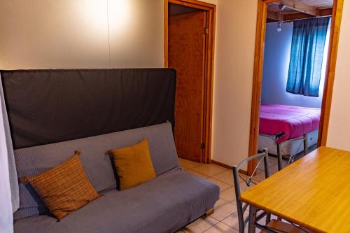 a living room with a couch and a table at Departamentos Aquario Papudo in Papudo
