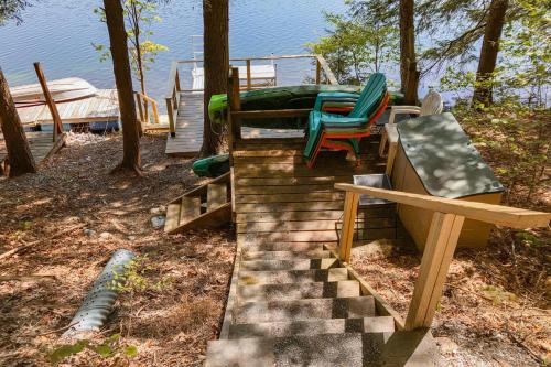 a set of stairs with two chairs and a bench at Beebe Pond Paradise in Castleton