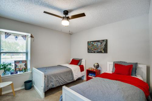 a bedroom with two beds and a ceiling fan at Darling Waxahachie Home with Yard and Fire Pit! in Waxahachie