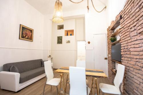 a living room with a couch and a table and chairs at casa vacanze Casa del Mare in Acitrezza