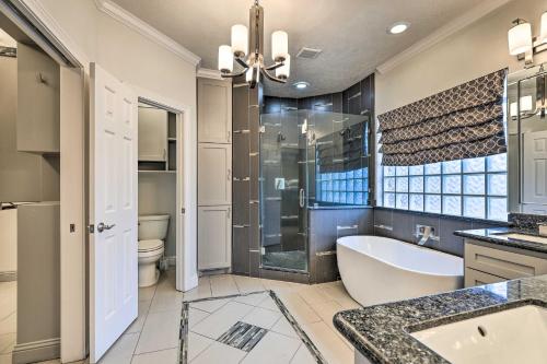 a bathroom with a tub and a shower and a sink at Fulshear Villa with Guest House and Scenic Views! in Brookshire