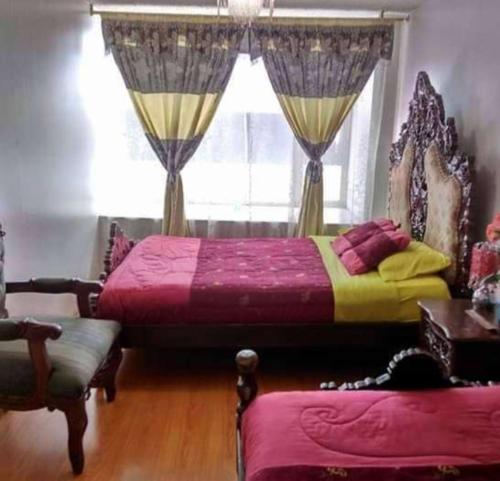a bedroom with two beds and a window at ESCOCIE-VA 1 in Quito