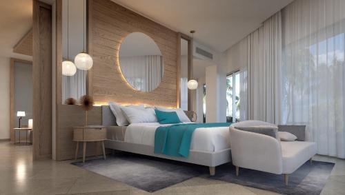 ein Schlafzimmer mit einem Bett, einem Stuhl und einem Spiegel in der Unterkunft Princess Senses The Mangrove Resort - Adults Only in Green Island