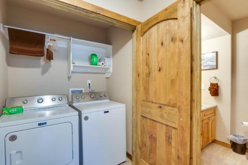 a laundry room with a washer and dryer and a wooden door at Crested Butte Getaway Near Skiing and Shopping! in Crested Butte