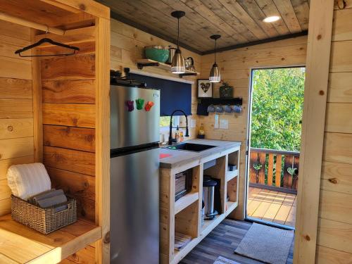 a kitchen with a stainless steel refrigerator in a cabin at Tiny Home By The Beach in Blaine