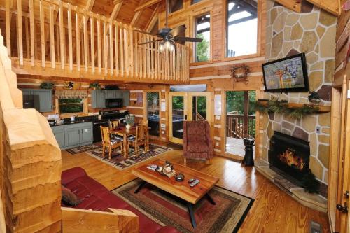 a living room with a fireplace in a log cabin at Mountain Splendor 1250 in Gatlinburg