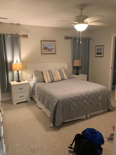 a bedroom with a bed and two night stands at Lavacanza in Little River