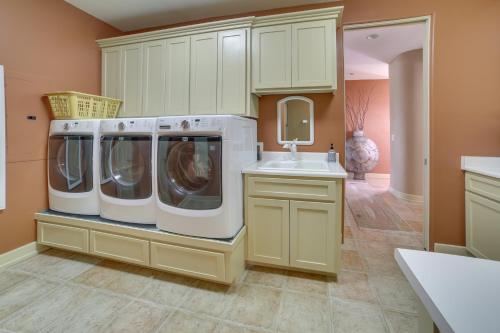 a laundry room with three washing machines and a sink at Chic California Escape with Pool, Hot Tub and Patio! in Salinas