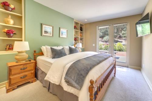 a bedroom with a large bed and a window at Chic California Escape with Pool, Hot Tub and Patio! in Salinas