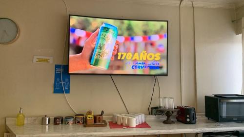 a flat screen tv hanging on a wall at Hostal del Prado in Temuco