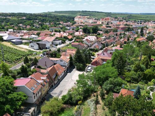 a town with a train in the middle of a village at Sommelierka in Valtice