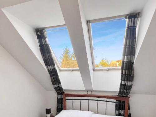 a bedroom with a bed and a window in a attic at Sommelierka in Valtice