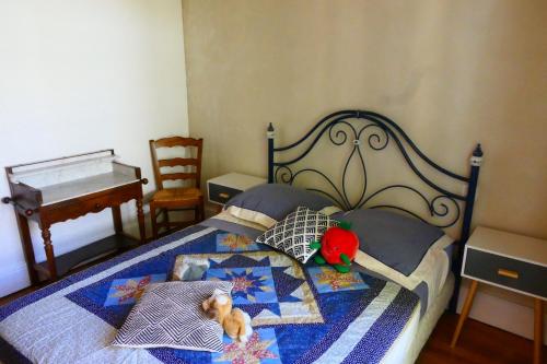 a bedroom with a bed with a stuffed animal on it at Maison en bord de Loire Le repaire du chat in Beaugency
