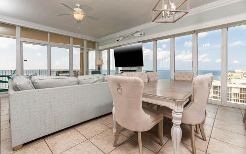 a living room with a couch and a table with chairs at Phoenix Gulf Shores 2001 condo in Gulf Shores