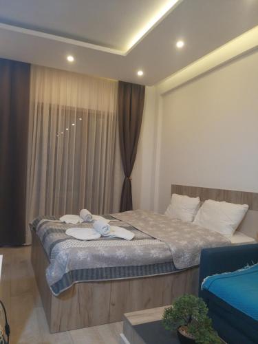 a bedroom with a large bed with towels on it at Ogy's apartment in Kopaonik