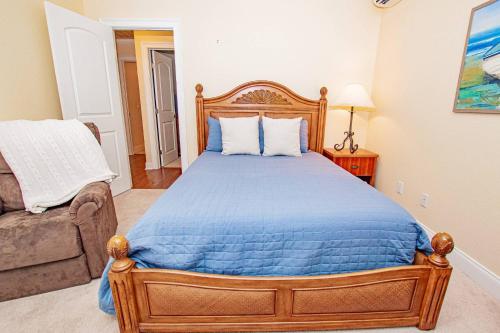 a bedroom with a wooden bed and a couch at Lake Howard Hideway in Winter Haven