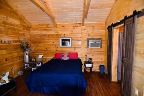 a bedroom with a bed in a log cabin at Foxtail Orchards - The Iron Horse in Tazewell